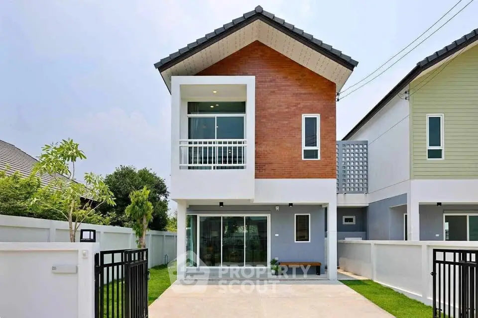 Modern two-story house with a stylish facade and small balcony, perfect for family living.