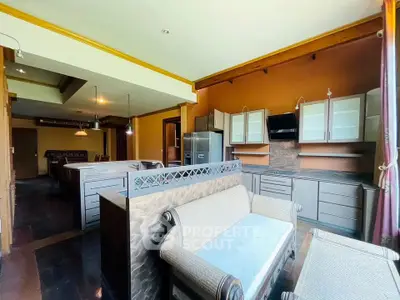 Spacious open-layout kitchen with elegant wooden cabinetry and modern appliances