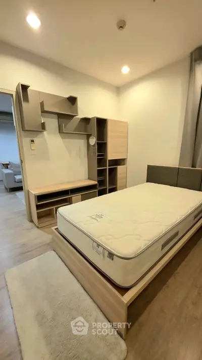 Modern bedroom with stylish shelving and comfortable mattress in a cozy apartment.