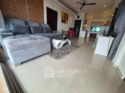 Spacious modern living room with plush gray sofa and stylish decor