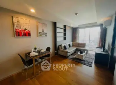 Modern living room with stylish decor and city view balcony in a high-rise apartment.