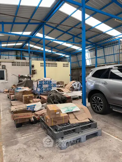 Spacious warehouse with ample storage space and vehicle access, ideal for logistics and inventory management.