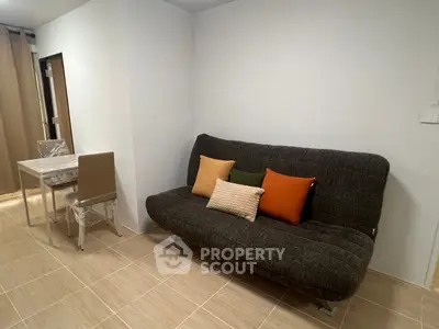 Modern living room with stylish sofa and dining area in a cozy apartment.