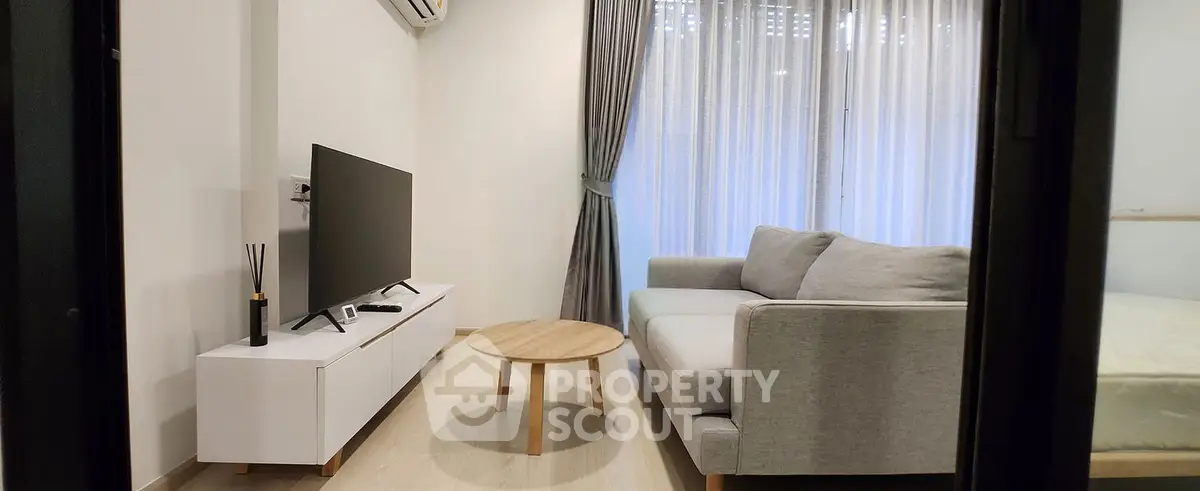 Modern living room with sleek furniture and natural light, perfect for relaxation and entertainment.