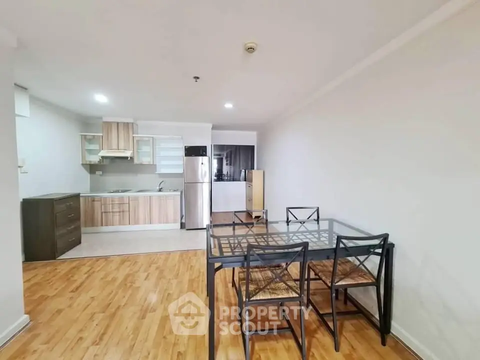 Spacious open-plan kitchen and dining area with modern appliances and wooden flooring.