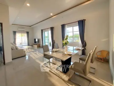 Spacious modern living room with elegant dining area and large windows