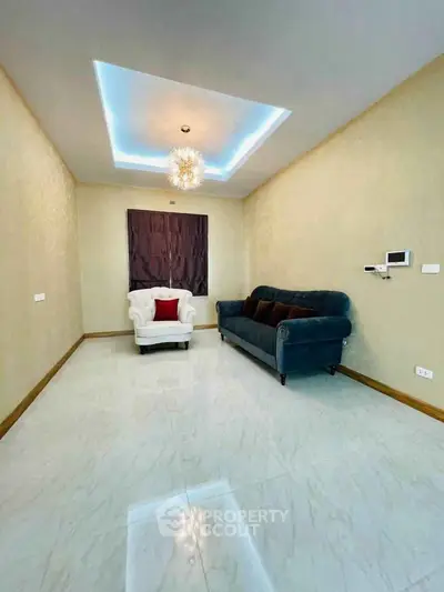 Elegant living room with modern lighting and plush seating in a contemporary home.