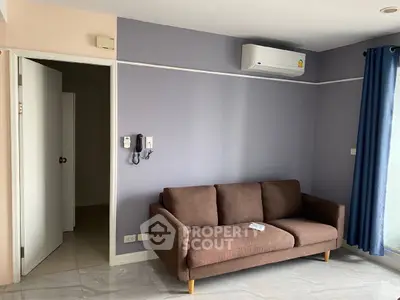 Modern living room with sleek brown sofa and air conditioning unit, perfect for cozy relaxation.