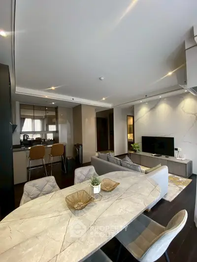 Modern open-plan living room with elegant dining area and sleek kitchen design.