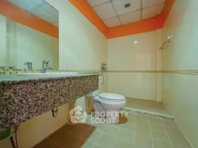 Spacious bathroom with modern fixtures and elegant tile design
