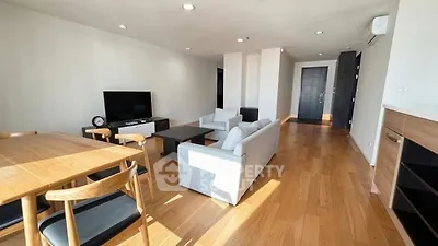 Spacious modern living room with wooden flooring and stylish furniture