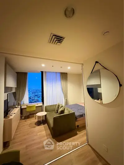 Modern studio apartment with city view, featuring cozy living area and stylish decor.