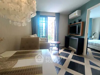 Stylish living room with modern decor and natural light, featuring a cozy seating area and a glimpse of the bedroom.