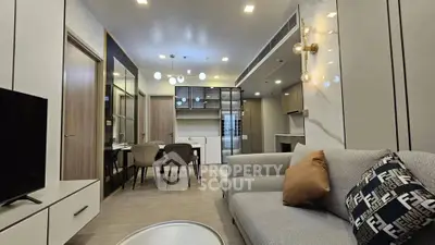 Modern living room with stylish decor and open kitchen layout in a contemporary apartment.