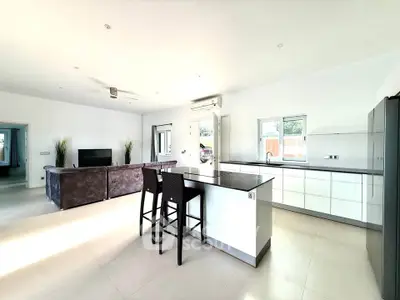 Spacious modern living room with open kitchen and sleek design