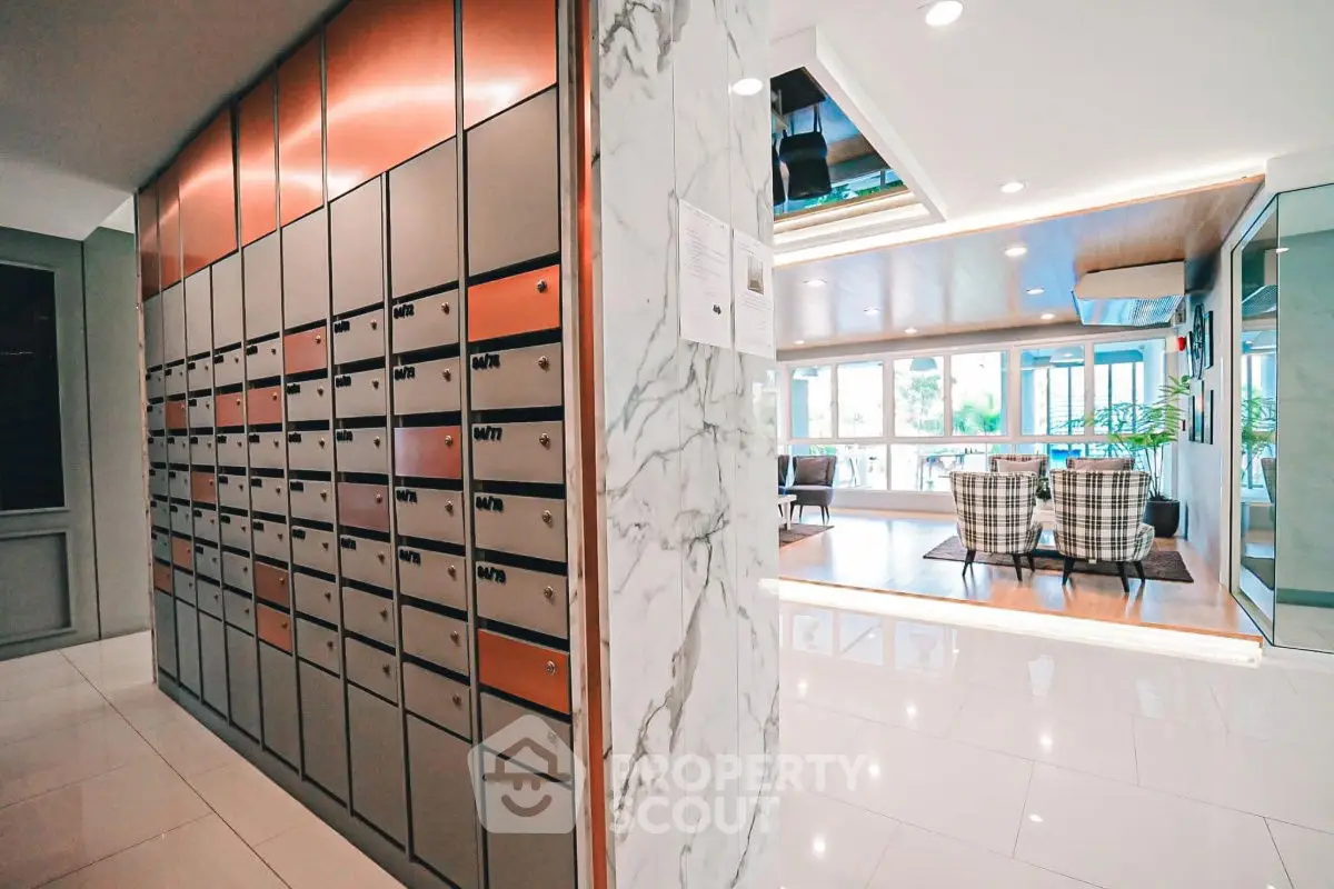 Modern apartment lobby with mailboxes and stylish seating area