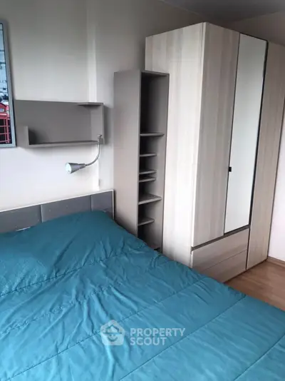Cozy bedroom with modern wardrobe and teal bedding