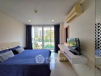 Spacious bedroom with balcony view in modern apartment