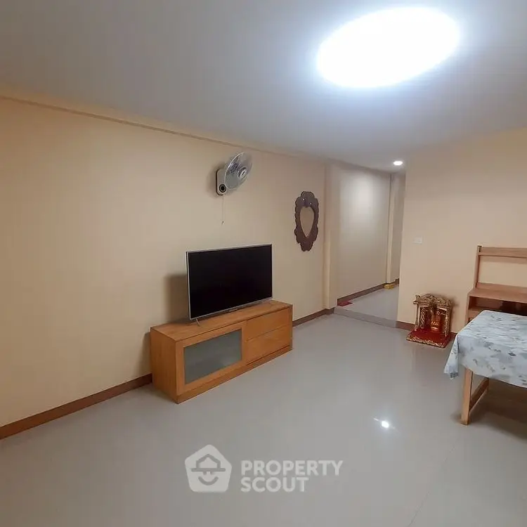 Spacious living room with modern TV setup and elegant decor