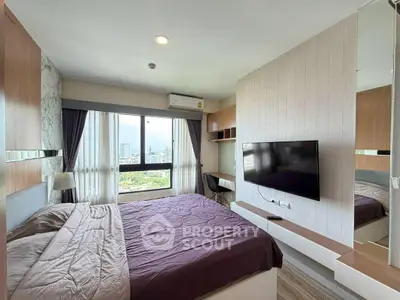 Modern bedroom with city view, featuring a wall-mounted TV and stylish decor.