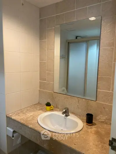 Modern bathroom with elegant sink and large mirror, perfect for a stylish home.