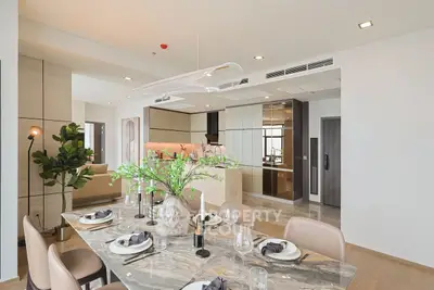 Luxurious open-plan dining and living area with modern decor and elegant finishes.