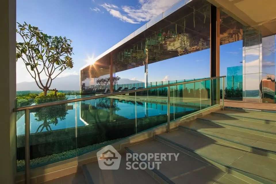 Luxurious rooftop pool with stunning panoramic views and modern glass architecture.
