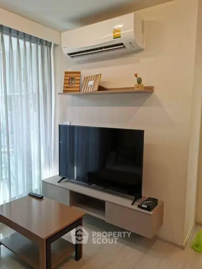 Modern living room with air conditioning and sleek TV setup