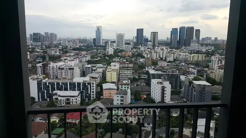 Stunning cityscape view from a high-rise balcony showcasing urban skyline and modern architecture.