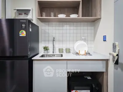 Modern compact kitchen with sleek appliances and stylish cabinetry