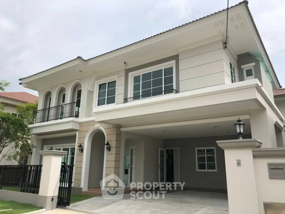 Elegant two-story modern house with spacious driveway and stylish facade.