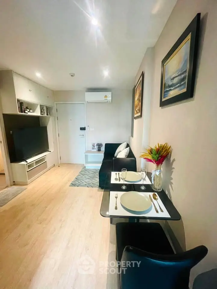 Modern living room with dining area, stylish decor, and cozy ambiance in a contemporary apartment.