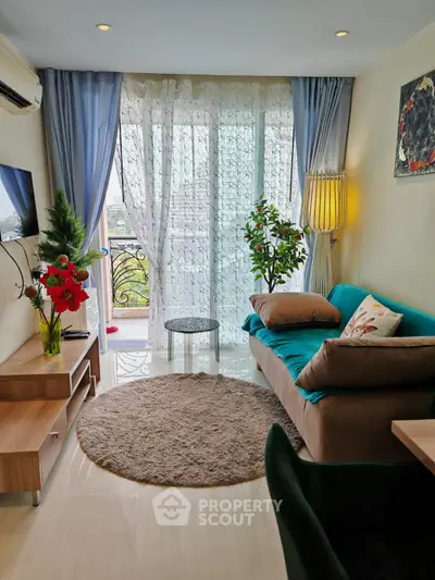 Charming living room with elegant decor and balcony view, perfect for relaxation and entertaining.