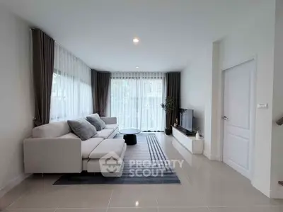 Spacious modern living room with elegant decor and large windows