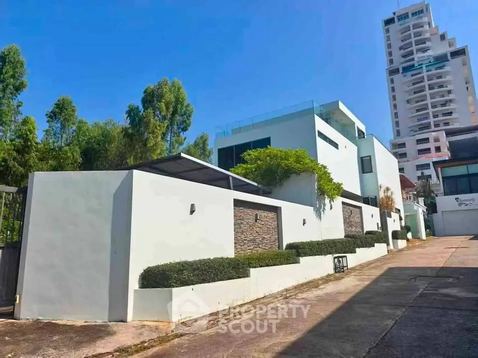 Modern luxury villa with sleek design and lush greenery in prime urban location.