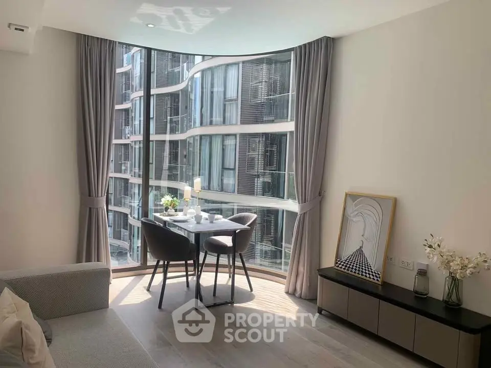 Modern living room with floor-to-ceiling windows and stylish dining area.