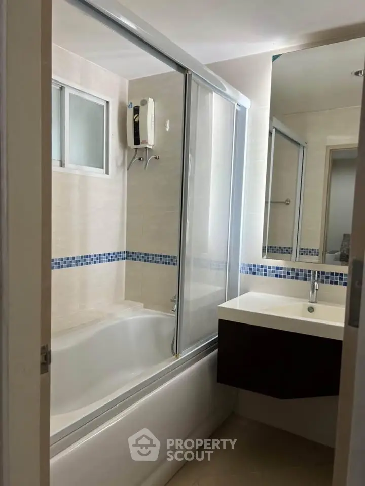 Modern bathroom with bathtub and sleek vanity in a stylish apartment.