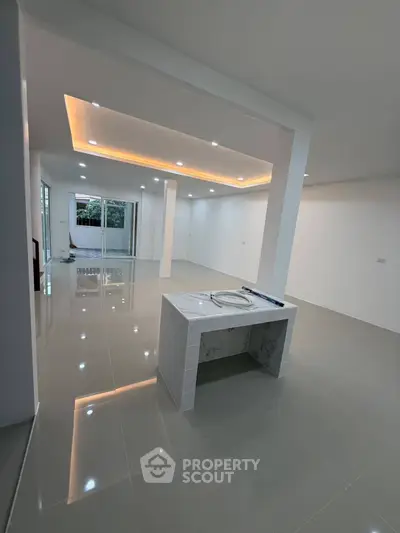 Spacious modern living room with sleek tile flooring and recessed lighting