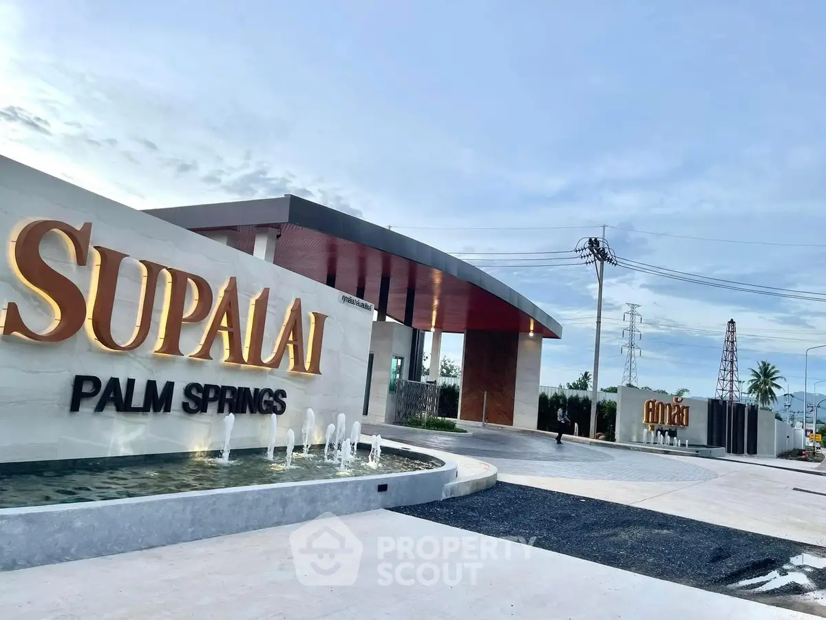 Luxurious entrance of Supalai Palm Springs with modern architecture and elegant signage.