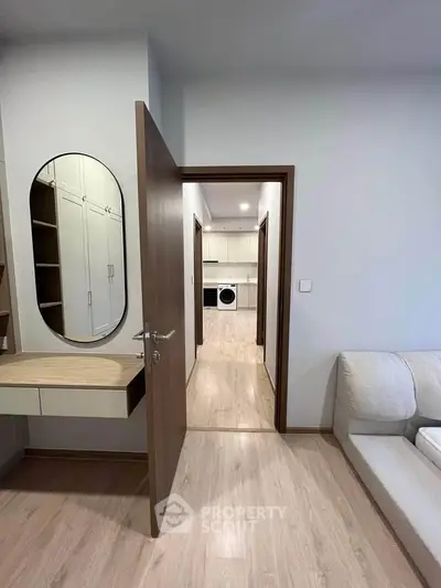 Modern apartment interior with open door view to kitchen and washing machine