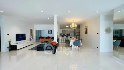 Spacious modern living room with open layout, elegant chandelier, and sleek furnishings in a luxurious home.