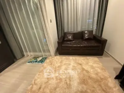 Cozy living room with plush rug and leather sofa, perfect for relaxation.