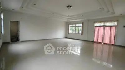 Spacious empty room with large windows and glossy floor, perfect for customization.