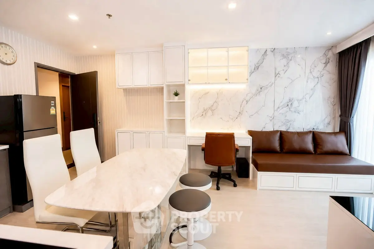 Modern open-layout living room with marble accents and stylish furniture