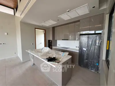 Modern kitchen with sleek cabinetry and island in new home construction.