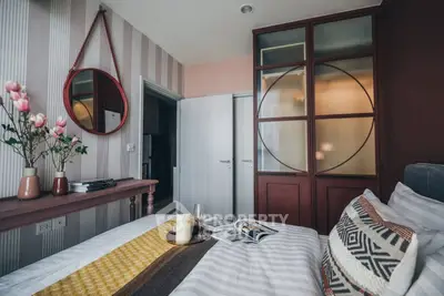 Chic bedroom with stylish decor, featuring a cozy bed, elegant mirror, and modern wardrobe design.
