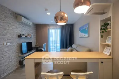 Modern living room with stylish decor and open layout, featuring a cozy seating area and contemporary lighting.