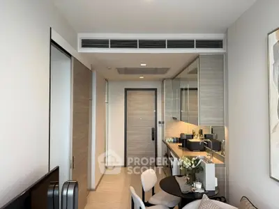 Modern apartment interior with sleek kitchen and dining area, featuring contemporary design and stylish decor.