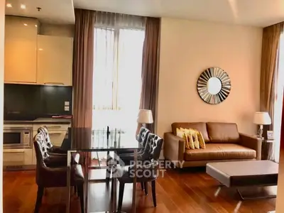 Modern living room with elegant decor, featuring a leather sofa, dining table, and stylish mirror.
