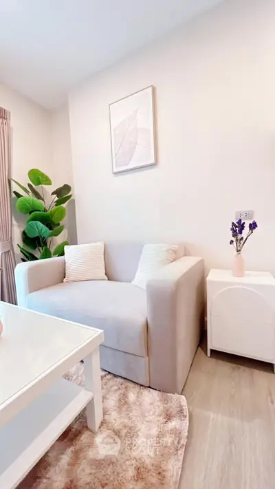 Cozy living room with modern decor, featuring a plush sofa, stylish coffee table, and vibrant indoor plant.